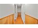 Bright hallway featuring wood floors, wainscotting, and white doors at 9811 Memorial Hwy, Tampa, FL 33615