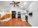 Well-lit kitchen featuring modern white cabinets, black appliances, and hardwood floors at 9811 Memorial Hwy, Tampa, FL 33615