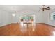 Bright living room with hardwood floors, chandelier, and access to screened-in porch at 9811 Memorial Hwy, Tampa, FL 33615