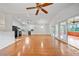 Open-concept living room featuring hardwood floors, vaulted ceilings, and access to the screened-in porch at 9811 Memorial Hwy, Tampa, FL 33615