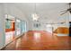 Open-concept living room with hardwood floors, high ceilings, and access to the screened-in porch at 9811 Memorial Hwy, Tampa, FL 33615