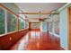 Inviting enclosed porch with wood accents, lots of natural light and an overhead ceiling fan at 9811 Memorial Hwy, Tampa, FL 33615