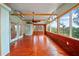 Enclosed porch featuring wood paneling, large windows, and a ceiling fan at 9811 Memorial Hwy, Tampa, FL 33615