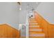 Staircase featuring decorative accents and wood paneling, leading up to the home's upper level at 9811 Memorial Hwy, Tampa, FL 33615