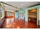 Bright sunroom boasts wood floors, exposed beams, with natural light through windows and glass doors at 9811 Memorial Hwy, Tampa, FL 33615