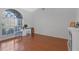 Bright living room with hardwood floors, fireplace, and a large arched window with natural light at 10221 Ashley Oaks Dr, Riverview, FL 33578