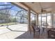 Relaxing screened patio with brick flooring, ceiling fans, and a lovely outdoor dining set at 10221 Ashley Oaks Dr, Riverview, FL 33578