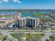 An attractive aerial view of Paradise Island Tower surrounded by water and lush landscaping at 10355 Paradise Blvd # 614, Treasure Island, FL 33706