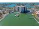 Overhead shot of a waterfront high-rise building featuring a pool, boat docks and parking at 10355 Paradise Blvd # 614, Treasure Island, FL 33706