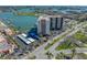 An aerial view of the building, parking area, and the stunning waterfront at 10355 Paradise Blvd # 614, Treasure Island, FL 33706