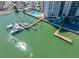 An aerial view showing boat docks, the pool, and the building near the waterfront at 10355 Paradise Blvd # 614, Treasure Island, FL 33706
