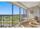 Enclosed balcony with seating overlooking waterfront and city views at 10355 Paradise Blvd # 614, Treasure Island, FL 33706