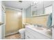 Bathroom featuring a tiled shower, toilet and vanity with an integral sink and a neutral color scheme at 10355 Paradise Blvd # 614, Treasure Island, FL 33706