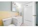 Bathroom featuring a toilet and vanity with an integral sink and adjacent doorway to closet at 10355 Paradise Blvd # 614, Treasure Island, FL 33706