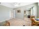 Bedroom featuring light green walls, light wood floors, closet with mirrored sliding doors and ceiling fan at 10355 Paradise Blvd # 614, Treasure Island, FL 33706