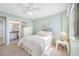 Cozy bedroom featuring a door into an ensuite bathroom and a ceiling fan at 10355 Paradise Blvd # 614, Treasure Island, FL 33706