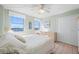 Bright bedroom featuring two windows, ceiling fan, and neutral walls at 10355 Paradise Blvd # 614, Treasure Island, FL 33706