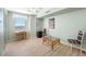 Bright bedroom featuring soft green walls, light wood floors, and a small work space by the window at 10355 Paradise Blvd # 614, Treasure Island, FL 33706