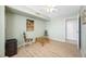 Bedroom with light green walls, light wood floors, ceiling fan and seating area with glass-topped table at 10355 Paradise Blvd # 614, Treasure Island, FL 33706
