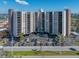 A beautiful exterior elevation view of Paradise Island Tower with parking and lush landscaping at 10355 Paradise Blvd # 614, Treasure Island, FL 33706