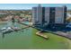 Exterior view showcasing the building, pool, boat docks and beautiful waterfront view at 10355 Paradise Blvd # 614, Treasure Island, FL 33706