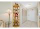 Hallway featuring shelving and a closet with white doors and white tile floor at 10355 Paradise Blvd # 614, Treasure Island, FL 33706