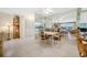Open concept living and dining area with tile flooring, mirrored walls and an adjacent kitchen with breakfast bar at 10355 Paradise Blvd # 614, Treasure Island, FL 33706