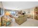 Bright living room features tile floors, balcony access and comfortable furniture at 10355 Paradise Blvd # 614, Treasure Island, FL 33706