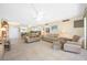 Open-concept living room featuring neutral furniture, tile floors, and ample natural light at 10355 Paradise Blvd # 614, Treasure Island, FL 33706