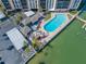 Overhead shot of a building's pool, cabana, docks, and parking lot at 10355 Paradise Blvd # 614, Treasure Island, FL 33706
