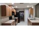 Functional kitchen with black appliances, wood cabinets, tile floors, and a stainless steel faucet at 11523 Jackson Manor Ct, Parrish, FL 34219