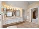 Spacious bathroom featuring a large mirror with decorative lighting and double sink vanity at 123 12Th E St, Tierra Verde, FL 33715