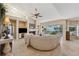 Bright living room with a fireplace and a large curved white sofa overlooking the water at 123 12Th E St, Tierra Verde, FL 33715