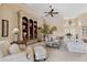 Bright living room featuring a large bookcase, plush seating, and a decorative ceiling fan for relaxed living at 123 12Th E St, Tierra Verde, FL 33715