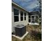 Cozy screened-in lanai and exterior windows in a private backyard setting at 1556 N River Cir, Tarpon Springs, FL 34689