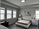 Neutral bedroom featuring recessed lighting, three windows, and an accent wall painting at 1556 N River Cir, Tarpon Springs, FL 34689