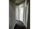 Carpeted hallway featuring multiple white paneled doors, baseboards, and light-gray walls at 1556 N River Cir, Tarpon Springs, FL 34689