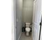 Powder room with a modern toilet, fresh paint and fixtures, and tile flooring at 1556 N River Cir, Tarpon Springs, FL 34689