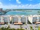 Condo building with manicured landscaping, garage parking and serene views of the beautiful bay in the distance at 17735 Gulf Blvd # 204, Redington Shores, FL 33708