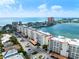 Breathtaking aerial view of beachfront condos, sparkling ocean, and the intercoastal waterway under a clear sky at 17735 Gulf Blvd # 204, Redington Shores, FL 33708