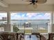 Relax on this waterfront balcony with comfortable seating and stunning views of the bay and boat dock at 17735 Gulf Blvd # 204, Redington Shores, FL 33708