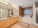 This bathroom has dual sinks, a soaking tub, and tile floors at 17735 Gulf Blvd # 204, Redington Shores, FL 33708