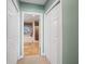 This hallway shows access to a bathroom with tiled floors, a walk in shower, and a soaking tub at 17735 Gulf Blvd # 204, Redington Shores, FL 33708