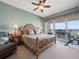 This bedroom features a ceiling fan, a water view, and a seating area at 17735 Gulf Blvd # 204, Redington Shores, FL 33708