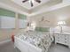 Bright bedroom featuring floral bedding, complemented by green accents and coordinated white furniture at 17735 Gulf Blvd # 204, Redington Shores, FL 33708