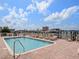 Sparkling community pool surrounded by lounge chairs and lush landscaping, perfect for relaxation and recreation at 17735 Gulf Blvd # 204, Redington Shores, FL 33708
