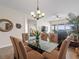 Open concept dining area featuring a glass-top table and seating for six at 17735 Gulf Blvd # 204, Redington Shores, FL 33708