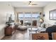 Bright living room with water views, comfortable seating, and a ceiling fan at 17735 Gulf Blvd # 204, Redington Shores, FL 33708