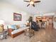 Comfortable living room with seating, massage chair, and view into kitchen and dining area at 17735 Gulf Blvd # 204, Redington Shores, FL 33708