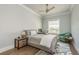 Comfortable bedroom with a wooden nightstand, desk, green chair, and large window view at 188 Brightwater Dr # 2, Clearwater Beach, FL 33767